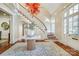 Spacious foyer with a striking staircase, elegant lighting fixture and beautiful hardwood flooring and millwork at 1333 Carlton Ave, Charlotte, NC 28203