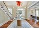Grand foyer featuring curved staircase, hardwood floors, and inviting chandelier at 1333 Carlton Ave, Charlotte, NC 28203
