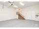 Spacious garage with stairs and an electric vehicle charging station at 1333 Carlton Ave, Charlotte, NC 28203