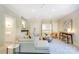 This spacious living room features a bar, a view to an upstairs landing, and white walls at 1333 Carlton Ave, Charlotte, NC 28203