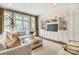 Bright living room with a wall of built-in cabinets and natural light from the French doors and windows at 1333 Carlton Ave, Charlotte, NC 28203