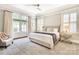 Tranquil main bedroom with double doors, a tray ceiling, a ceiling fan and plenty of natural light at 1333 Carlton Ave, Charlotte, NC 28203