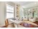 Bright sitting room with large windows, custom built-ins, and cherry hardwood floors at 1333 Carlton Ave, Charlotte, NC 28203