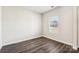 Bedroom featuring hardwood floors, neutral walls, and a window for natural light at 1515 Harper Landing Blvd, Stanley, NC 28164