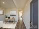 Bright entryway with hardwood floors, leading to a home office and other rooms at 1515 Harper Landing Blvd, Stanley, NC 28164