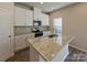 Modern kitchen with white cabinets and granite island at 1515 Harper Landing Blvd, Stanley, NC 28164