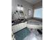 Bright bathroom features a double vanity with a granite countertop and a large soaking tub at 1601 Eden Glen Dr, Dallas, NC 28034