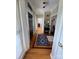 Inviting entryway featuring hardwood floors, a stylish rug, and a dark wood front door at 1601 Eden Glen Dr, Dallas, NC 28034