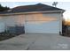 Two-car garage with white doors and concrete driveway at 1601 Eden Glen Dr, Dallas, NC 28034