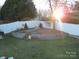 Landscaped backyard with retaining wall and circular sitting area at 1601 Eden Glen Dr, Dallas, NC 28034