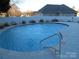 Inviting kidney-shaped pool with concrete decking at 1601 Eden Glen Dr, Dallas, NC 28034