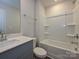 Bathroom featuring a tub, shower combo, modern vanity, and neutral tones at 1608 Village Grove Ln, Monroe, NC 28110