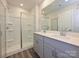 Bathroom featuring double sink vanity, glass shower, and modern finishes at 1608 Village Grove Ln, Monroe, NC 28110