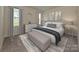 Serene bedroom with a large window, neutral tones, and elegant decor at 1608 Village Grove Ln, Monroe, NC 28110