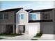 Two-story townhome with a one-car garage, gray siding, and a welcoming front entrance at 1608 Village Grove Ln, Monroe, NC 28110