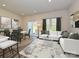 Bright living area with a comfortable sofa, stylish rug, and adjacent dining space at 1608 Village Grove Ln, Monroe, NC 28110