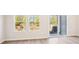 Bright living room with large windows, sliding glass doors and wood-look floors at 1608 Village Grove Ln, Monroe, NC 28110