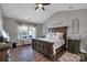 Main bedroom features a king-size bed, large windows, and trey ceiling at 163 Paradise Hills Cir, Mooresville, NC 28115