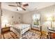 Comfortable bedroom featuring a cozy bed with patterned bedding, complemented by a wooden desk and chair at 16415 Capps Rd, Charlotte, NC 28278