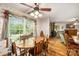 Cozy dining room with a wooden table and chairs, brightened by natural light from a large window with views of the yard at 16415 Capps Rd, Charlotte, NC 28278