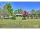 Beautiful landscaped front yard with mature trees and a charming wooden gazebo at 16415 Capps Rd, Charlotte, NC 28278