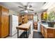 Functional kitchen with a large island, appliances, wooden cabinets, and a view of the living area at 16415 Capps Rd, Charlotte, NC 28278