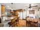 Warm kitchen with wood cabinets, island, and a dining area with floral wallpaper at 16415 Capps Rd, Charlotte, NC 28278