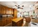 Inviting kitchen features wood cabinets, island and hardwood floors, flowing into a bright dining area at 16415 Capps Rd, Charlotte, NC 28278
