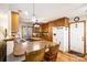 Charming kitchen features wood cabinets, breakfast bar, and appliances with a floral wallpaper accent at 16415 Capps Rd, Charlotte, NC 28278