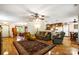 Open-concept living room with hardwood floors, wood furniture, and seamless flow to the dining and kitchen at 16415 Capps Rd, Charlotte, NC 28278