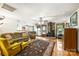 Spacious living room with stone fireplace, wood floors, and a large decorative rug at 16415 Capps Rd, Charlotte, NC 28278