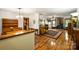 Open-concept living room with hardwood floors, wood furniture, and seamless flow to the dining and kitchen at 16415 Capps Rd, Charlotte, NC 28278