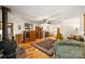 Cozy living room with wood-burning stove, hardwood floors, and a decorative area rug at 16415 Capps Rd, Charlotte, NC 28278