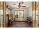 Charming office space with french doors, hardwood floors, and a desk area with shelves, as well as a piano at 16415 Capps Rd, Charlotte, NC 28278