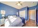 Spacious bedroom with blue walls, king-size bed, and double doors to closet at 205 Picasso Trl, Mount Holly, NC 28120