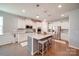 Kitchen island with granite countertop and seating for three at 205 Picasso Trl, Mount Holly, NC 28120