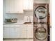 Laundry room with stacked washer/dryer, white cabinets and countertop at 205 Picasso Trl, Mount Holly, NC 28120