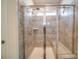 Large walk-in shower with glass enclosure and tiled walls at 205 Picasso Trl, Mount Holly, NC 28120