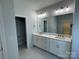 Double vanity bathroom with a large mirror and quartz countertop at 208 Beths Ct # 35, York, SC 29745