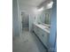 Bright bathroom featuring a double sink vanity, marble countertops, and tile flooring at 208 Beths Ct # 35, York, SC 29745