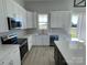 Modern kitchen with white cabinets, island, and stainless steel appliances at 208 Beths Ct # 35, York, SC 29745