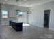 Modern kitchen with white cabinets, large island, and stainless steel appliances at 208 Beths Ct # 35, York, SC 29745