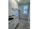 Bright laundry room with a sink and overhead shelving at 208 Beths Ct # 35, York, SC 29745