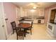 Kitchen with white cabinets and a round dining table at 2913 & 2901 Wesleyan Church Rd, Lincolnton, NC 28092