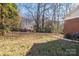 Large backyard with a grill and mature trees at 2919 Bellaire Dr, Charlotte, NC 28216