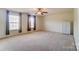 Spacious bedroom with neutral carpeting, two large windows, and ceiling fan at 3043 Streamlet Way, Monroe, NC 28110