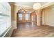 Open dining room with hardwood floors, neutral walls, and views into the foyer and living areas at 3043 Streamlet Way, Monroe, NC 28110