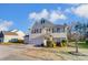 Two-story house with beige siding, dark shutters, and a two-car garage at 3043 Streamlet Way, Monroe, NC 28110