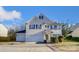Two-story house with beige siding, dark shutters, and a two-car garage at 3043 Streamlet Way, Monroe, NC 28110