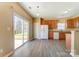 Bright kitchen features wood cabinets, granite countertops, and a sliding glass door leading to the backyard at 3043 Streamlet Way, Monroe, NC 28110